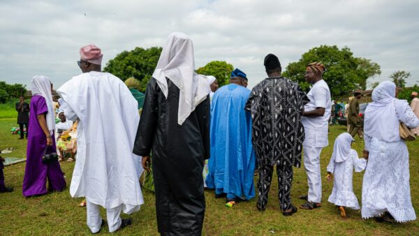 A group of people in traditional attire gathered outdoors