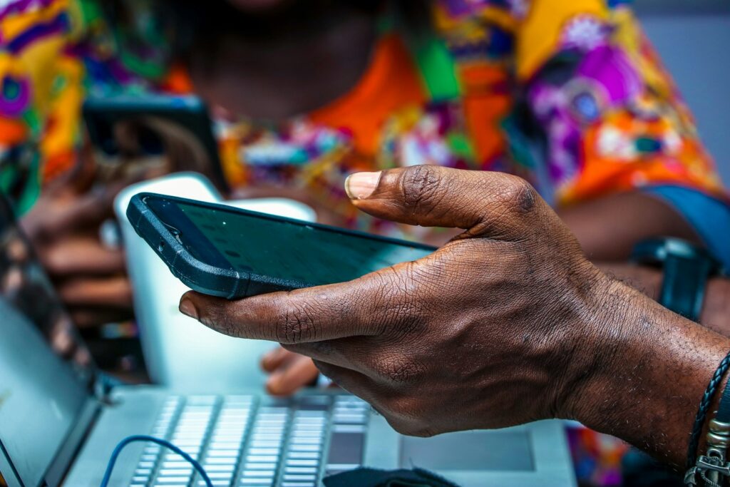 A person holding a black Android smartphone