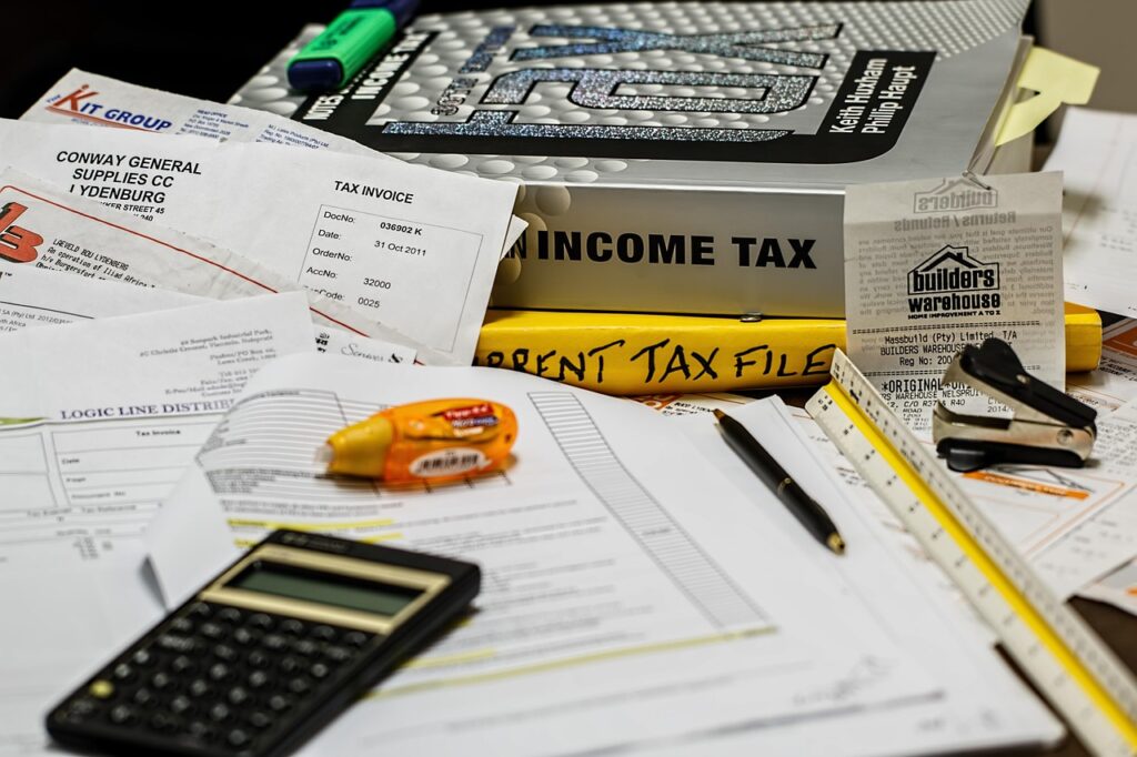 Income tax paperwork on a desk with a calculator