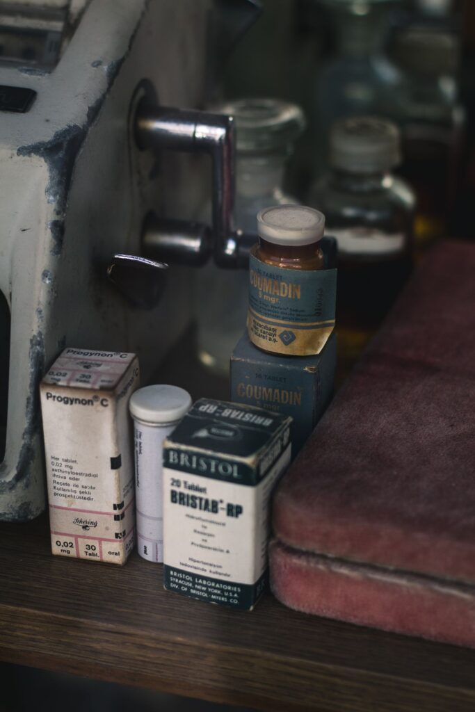 Various medicines in boxes and blister packs laid out on a table