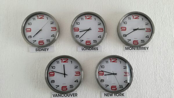 Wall clocks showing the time in different world time zones