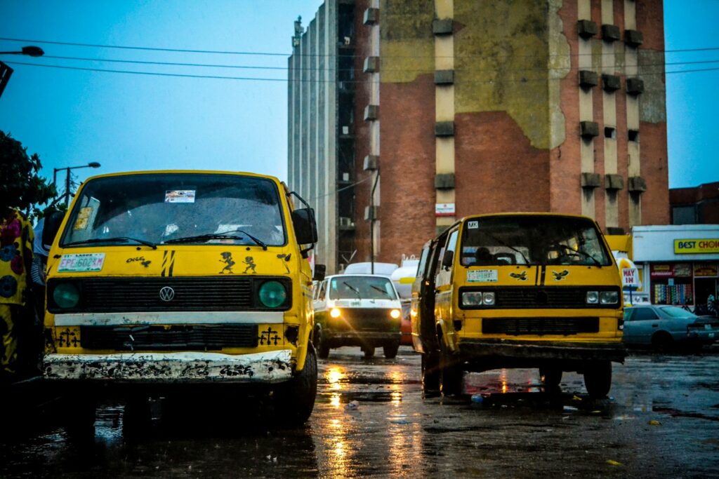 Yellow commercial buses on a road during the day