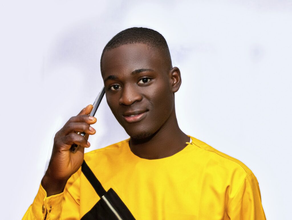 A young man holding a mobile phone to his ear